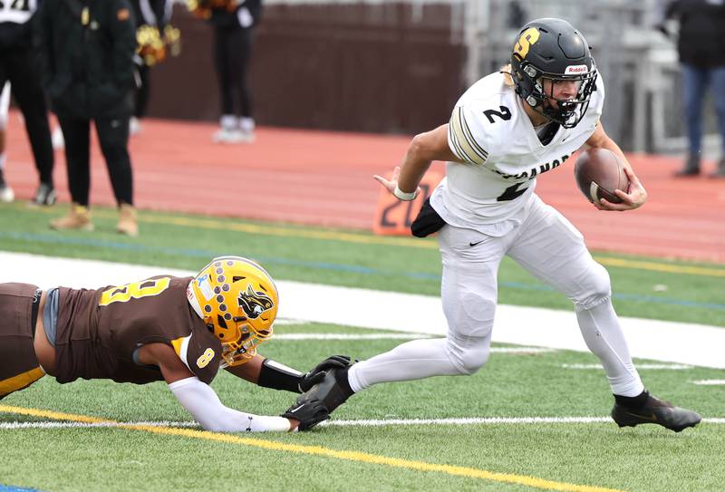 Sycamore's Elijah Meier escapes from Carmel's Harlon May on his way to the end zone during their Class 5A second round playoff game Saturday, Nov. 5, 2022, at Carmel Catholic High School in Mundelein.