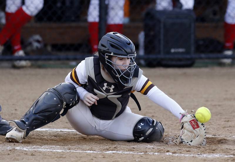 Jacobs’ Sam Wines tries to catch a pitch during a non-conference softball game against Palatine Monday, March 20, 2023, at Palatine High School.