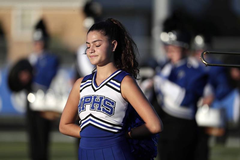 Highland Park Cheerleader Sabrina Musen, 16, pauses during a moment of silence Friday August 26, 2022 in Highland Park.