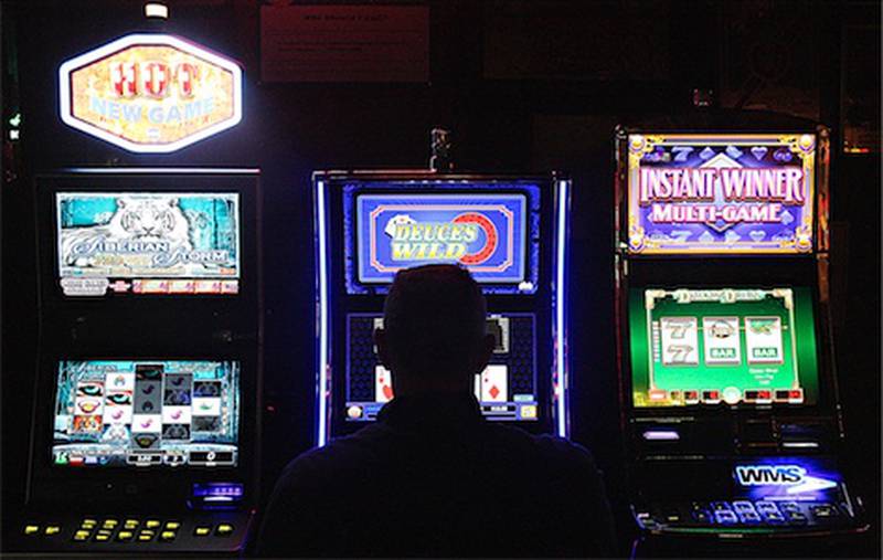 David Busch plays one of the new video gambling machines Friday at Houlahan’s Tavern in Waterman. The tavern, which has three gambling machines, is one of the first in DeKalb County to have terminals up and running.