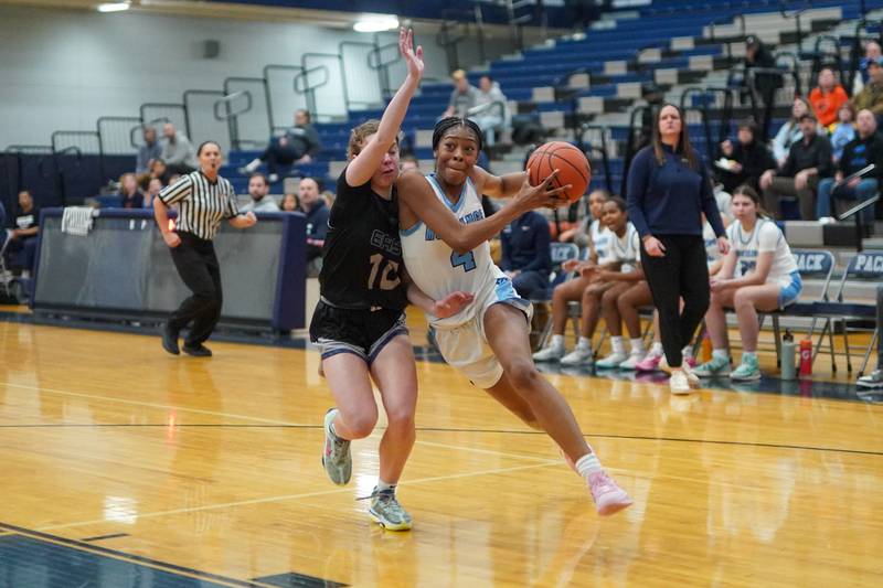 Downers Grove South's Hayven Harden (4) drives to the hoop against Oswego East's Myella Dart (10) during a 4A Oswego East Regional semifinal girls basketball game at Oswego East High School on Monday, Feb 12, 2024.