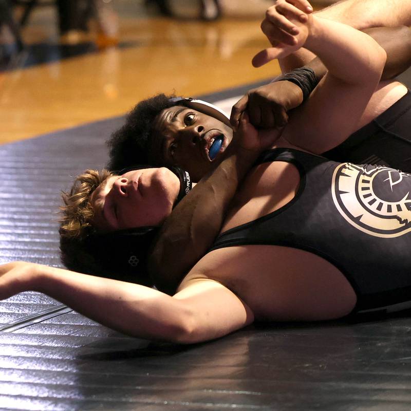 DeKalb’s Cam Matthews scores points against Sycamore’s Douglas Gemberling Friday, Jan. 17, 2025, during their 165 pound match at DeKalb High School.