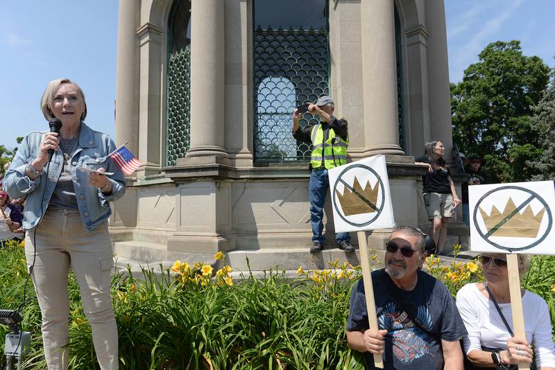 DuPage County Recorder Liz Chaplin marches alongside participants of the nationwide No Kings Day Rally including Minas and Michelle Karoutsos of Berkely during the rally held in Elmhurst Saturday June 14, 2025. The rally stated at Elmhurst City Hall to Glas Memorial Park back to City Hall.