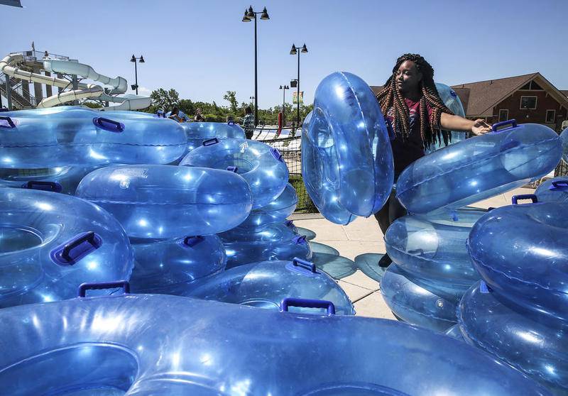 Crews at Splash Station stack several inner tubes  Wednesday, May 31, 2017, in preparation for the summer season in Joliet, Ill.