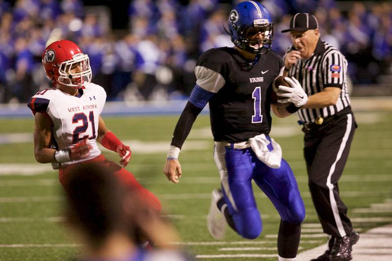 Geneva's Sean Chambers advances the ball until run out of bounds by West Aurora's DaQuan Cross on Friday in Geneva.