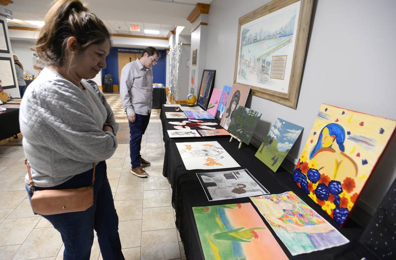 Nazareth parents Erika and Phil Capodice of Lagrange Park look at art students work during the Expressive Arts Showcase held Monday, April 8, 2024.