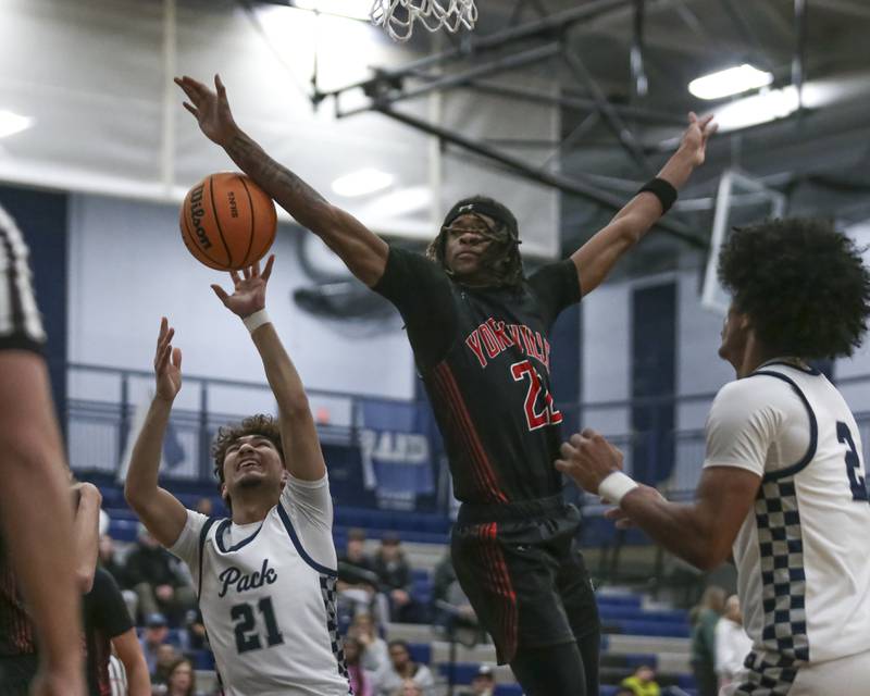 Yorkville's Braydon Porter (22) blocks a shot from Yorkville's Frankie Pavlik (21) out of bounds during their basketball game between Yorkville at Oswego East. Friday, Dec 19, 2025 in Oswego.