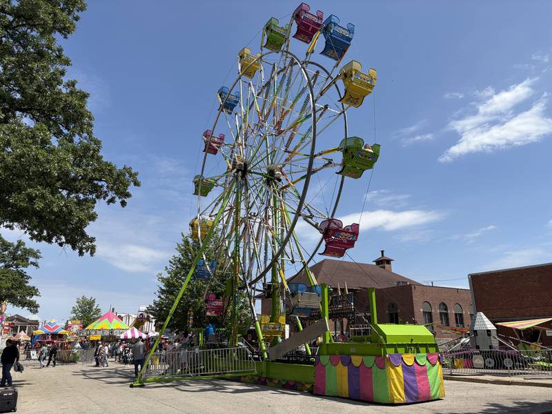 A Ferris wheel turns as festivalgoers enjoy rides and attractions Saturday, May 24, 2025, during Park Fest at Streator’s City Park.