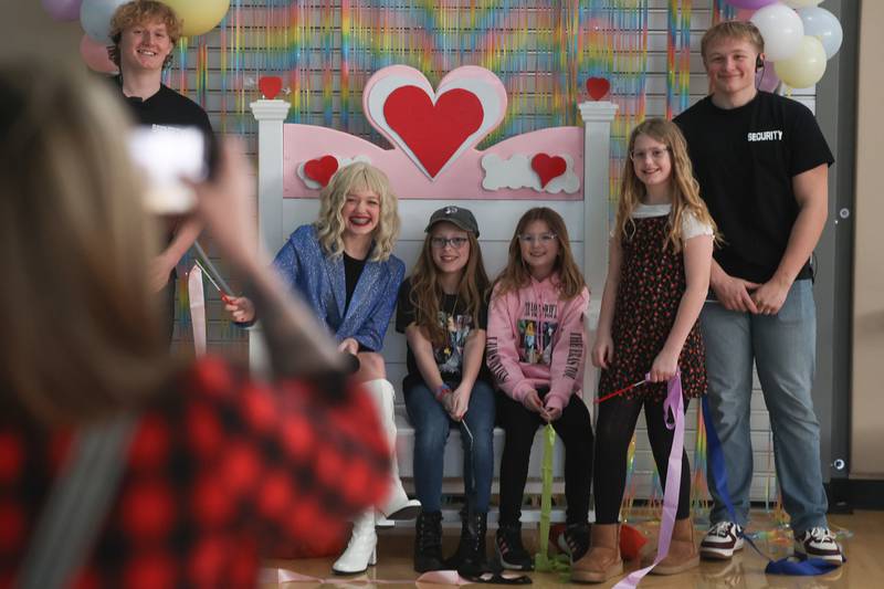 A group of Swifties get their photo taken with “Taylor Swift” at the Taylor Swift fan party hosted by the Lockport Township Park District on Saturday, Feb. 10, 2024 in Lockport.