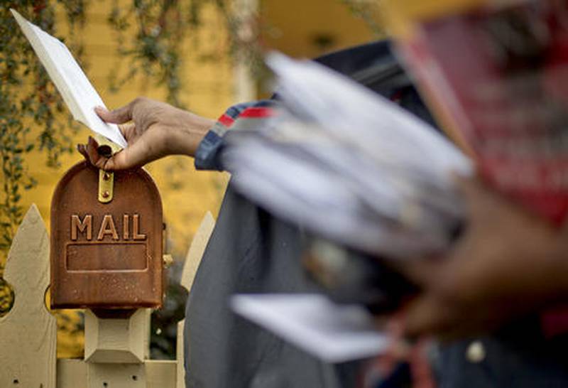 U.S. Postal Service letter carrier Jamesa Euler delivers mail in Atlanta. The financially struggling Postal Service is seeking a 3-cent increase in the cost of mailing a letter, bringing the price of a first-class stamp to 49 cents.