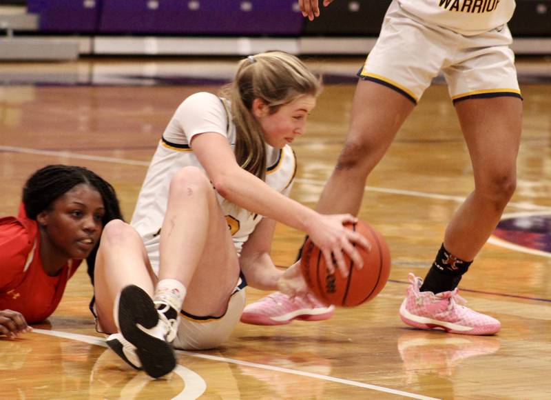 Sterling's Olivia Melcher (12) hits the floor to snag the loose ball and keep possession on Wednesday during the Dixon KSB Holiday Classic. Melcher had 14 points and three steals in a 41-37 Sterling loss to Rockford Jefferson.