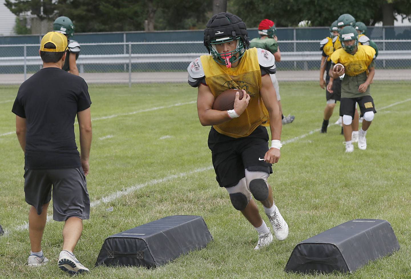 Crystal Lake South’s Aiden Lira runs with the ball during football practice on Wednesday, July 23, 2025, at Crystal Lake South High School.