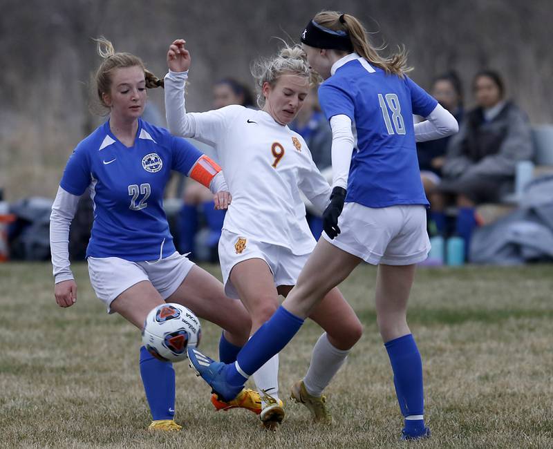 Richmond-Burton's Reese Frericks has the ball kicked away by Woodstock's Lily Novelle, right, and Woodstock's Reese Freund, left, during a Kishwaukee River Conference soccer match Wednesday, April 30, 2022, between Richmond-Burton and Woodstock at Creekside Middle School.
