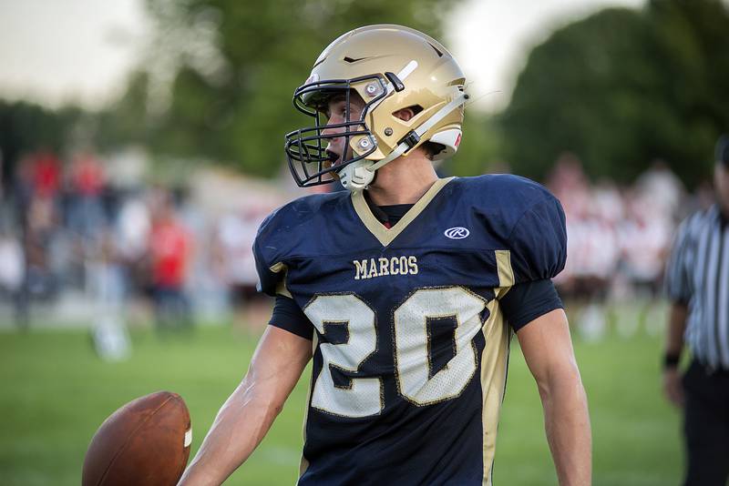Polo’s Avery Grenoble tosses the ball to the ref after a touchdown against Amboy Friday, Aug. 26, 2022.