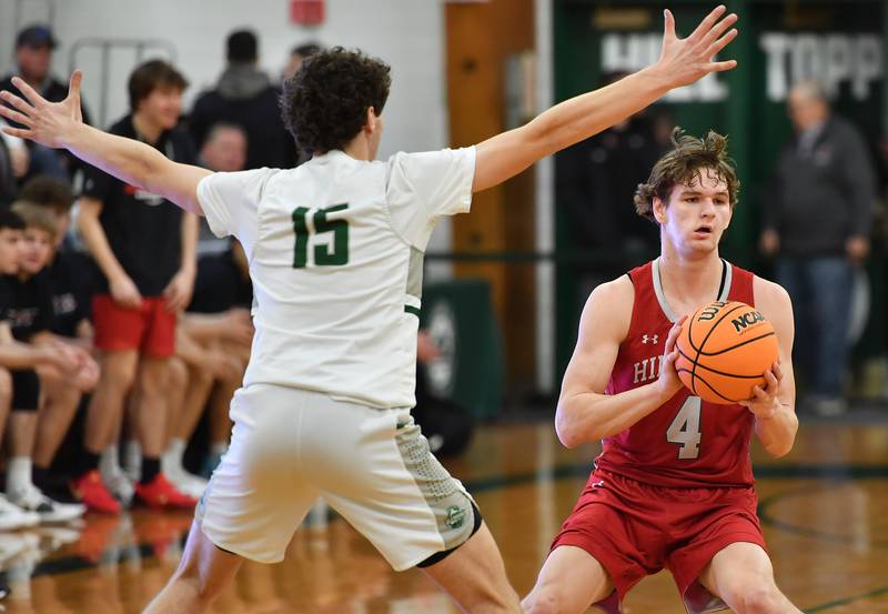 Hinsdale Central’s Vincas Buzelis (4) starts to pass as Glenbard West’s Drew Gacek (15) defends during a game on January 31, 2025 at Glenbard West High School in Glen Ellyn.