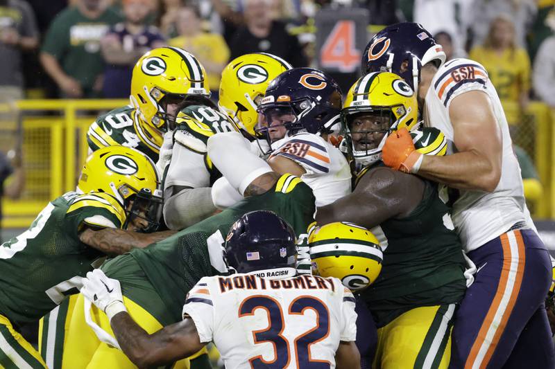 Chicago Bears quarterback Justin Fields, center, is stopped short of the goal line on a fourth down run during the second half against the Green Bay Packers Sunday, Sept. 18, 2022, in Green Bay, Wis.