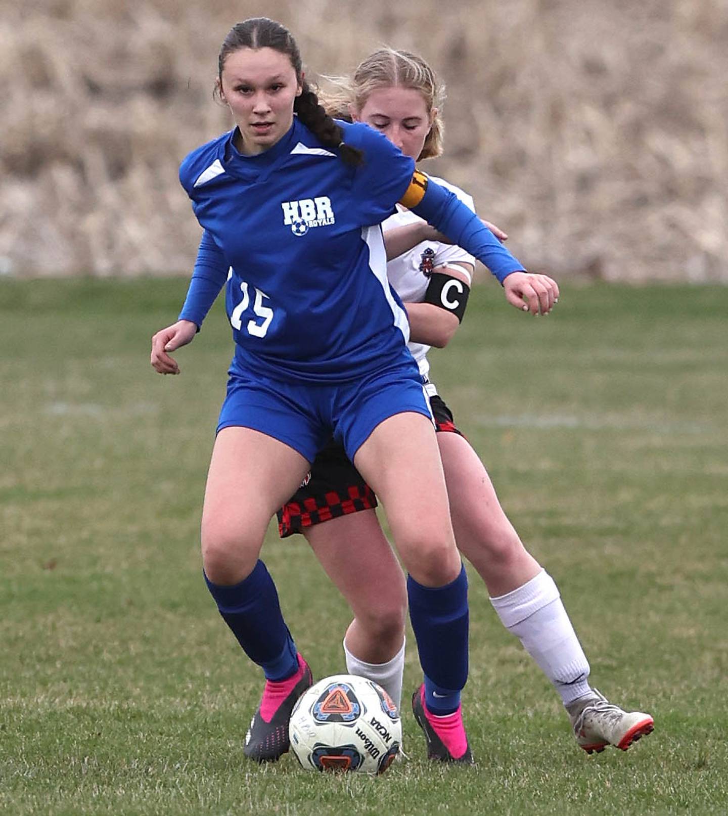 Hinckley-Big Rock co-op's and Somonauk's Josie Rader holds off Indian Creek's Jolee Larson during a match last season at Hinckley-Big Rock High School.
