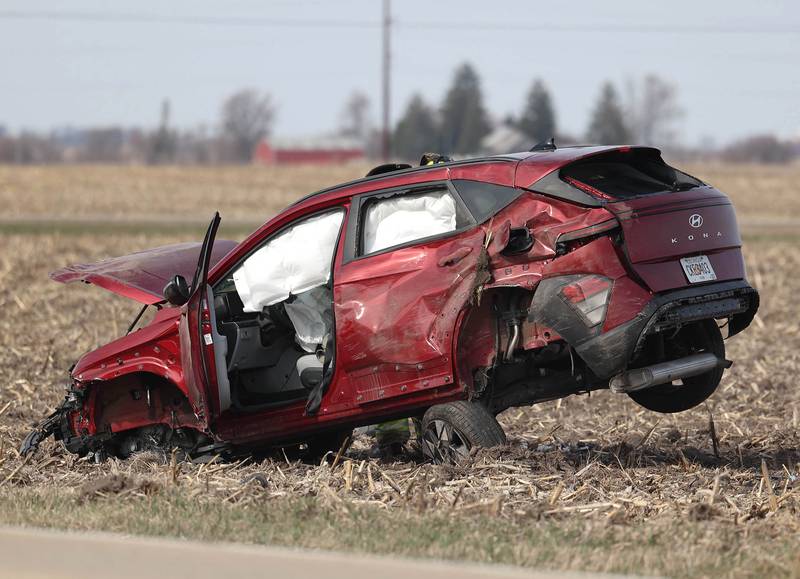 A badly damaged vehicle sits in a cornfield on the east side of Somonauk Road south of McGirr Road Wednesday, March 25, 2026, after a two vehicle crash near Hinckley.
