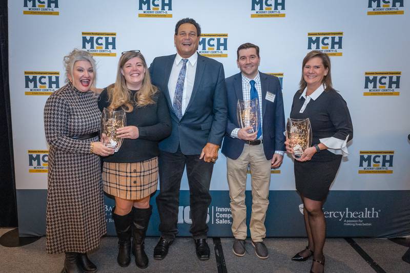 McHenry County Economic Development Corporation award winners with former Chicago Bears football player Dan Hampton (from left to right): Molly Ostap and Amy Humbracht of the McHenry Area Chamber of Commerce; Dan Hampton; Lucas Muriello of U.S. Medical Glove Company; and Jennifer Johnson of Exemplar.