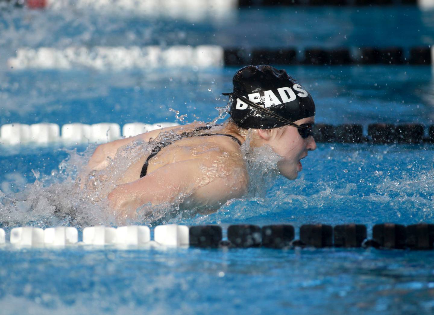 Rosary’s Becky Rentz competes in the 100-yard butterfly championship heat during the IHSA Girls State Swimming and Diving Championships at the FMC Natatorium in Westmont on Saturday, Nov. 11, 2023.