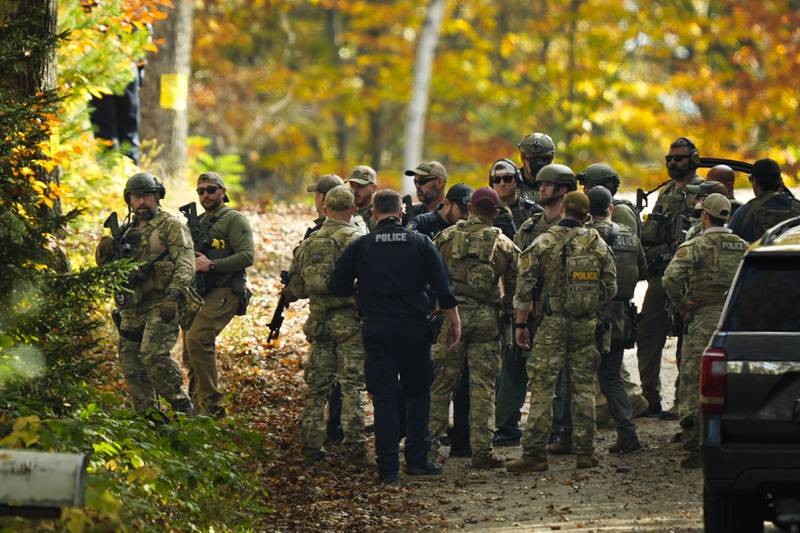 Law enforcement continue a manhunt in the aftermath of a mass shooting, in Durham, Maine, Friday, Oct. 27, 2023.   Authorities are scouring hundreds of acres of family-owned property, sending dive teams to the bottom of a river and scrutinizing a possible suicide note in the second day of their intensive search for an Army reservist accused of fatally shooting several people in Maine.(AP Photo/Matt Rourke)