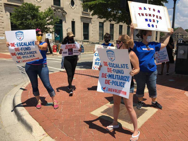 Protesters gather on a street corner near Joliet Mayor Bob O'Dekirk's law firm on Friday to demand his resignation.