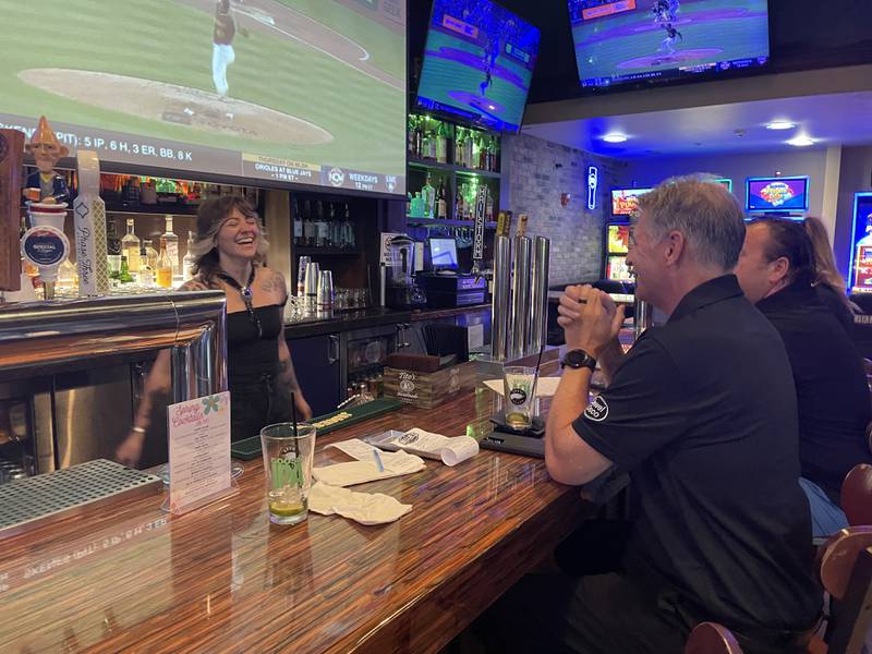 Bartender Kailah Goble of Palatine shares a laugh with customers at Durty Nellie's Gastropub & Concert Hub on a recent Wednesday.