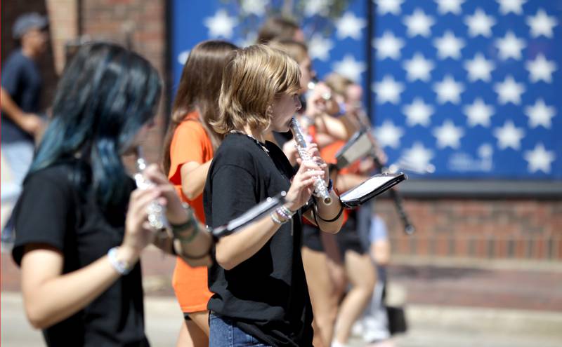 Members of the St. Charles East Marching Band perform during the school’s homecoming parade on Main Street through Downtown St. Charles on Thursday, Aug. 31, 2023.