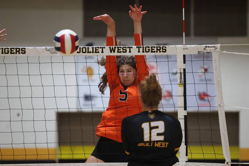 Lincoln-Way West’s Caroline Smith blocks a shot for the point against Joliet West on Tuesday, Sept. 12, in Joliet.