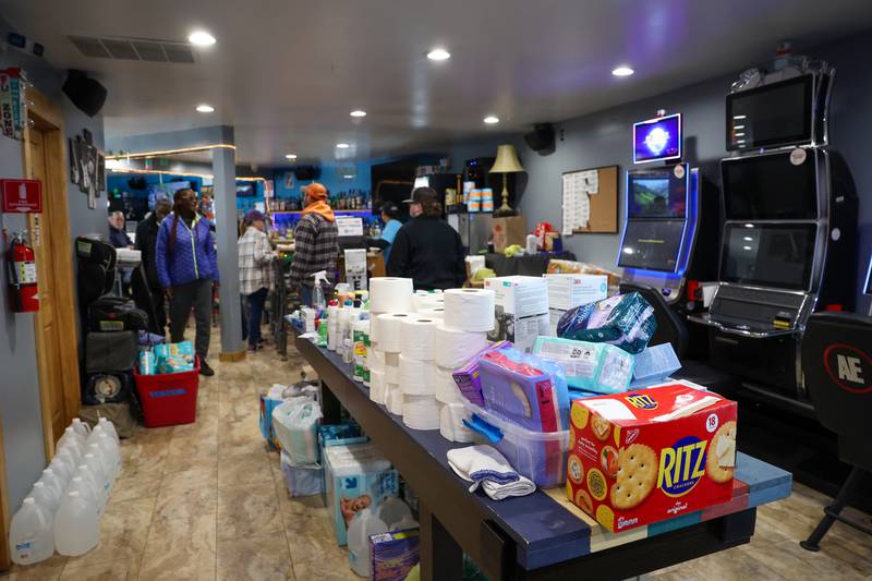 Donations fill a table at the Fun Hub on March 12, 2026. The small bar transformed into a bustling hub of supplies, food and resources following the March 10 tornado that caused destruction in Aroma Township and across Kankakee County.