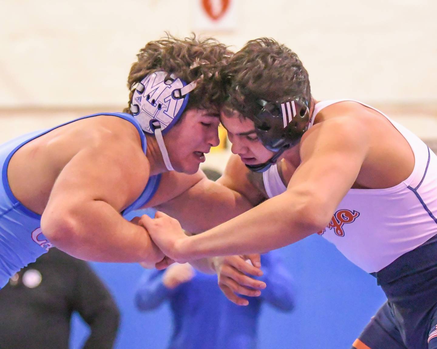 Marmion's Joey Fvia, left, goes head to head with Oswego Cruz Ibarra during the 195-pound championship match at the Class 3A Marmion Regional on Saturday.