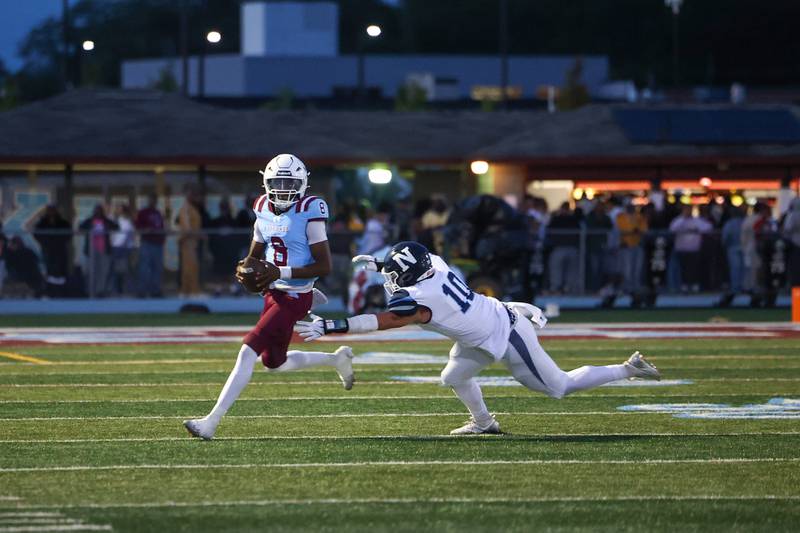 Kankakee's Kymani Billings looks to pass as Nazareth's John Bukovac makes the tackle during Kankakee's 33-12 loss to Nazareth on Friday, Aug. 29, 2025.