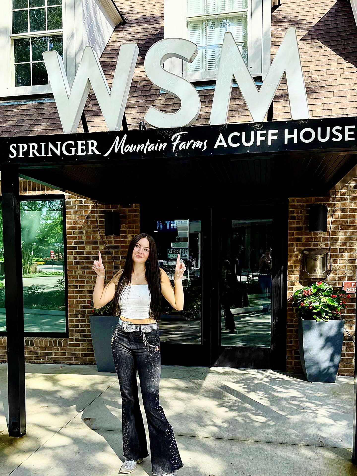 McKenna Faith Winters poses in front of Nashville radio station WSM, where the Dixon native and Machesney Park resident gave a live country music performance on July 8.
