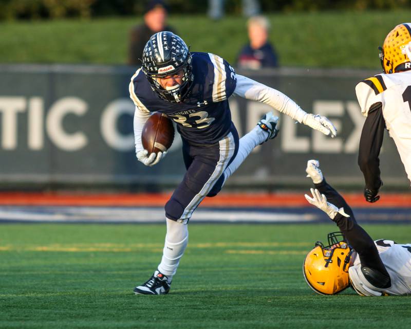 IC Catholic Prep's Joey Gliatta (33) runs to the outside during Class 4A third round playoff football game between St Laurence at IC Catholic Prep.  Nov 11, 2023.