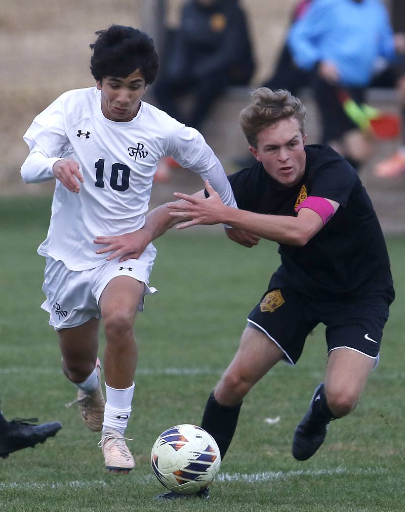 Richmond-Burton's Nathaniel Larson tries to slow down F.W. Parker's Rohan Liew as he pusses the ball toward the goal during an IHSA Class 1A Johnsburg Sectional semifinal match on Oct. 28, 2025, at Johnsburg High School.