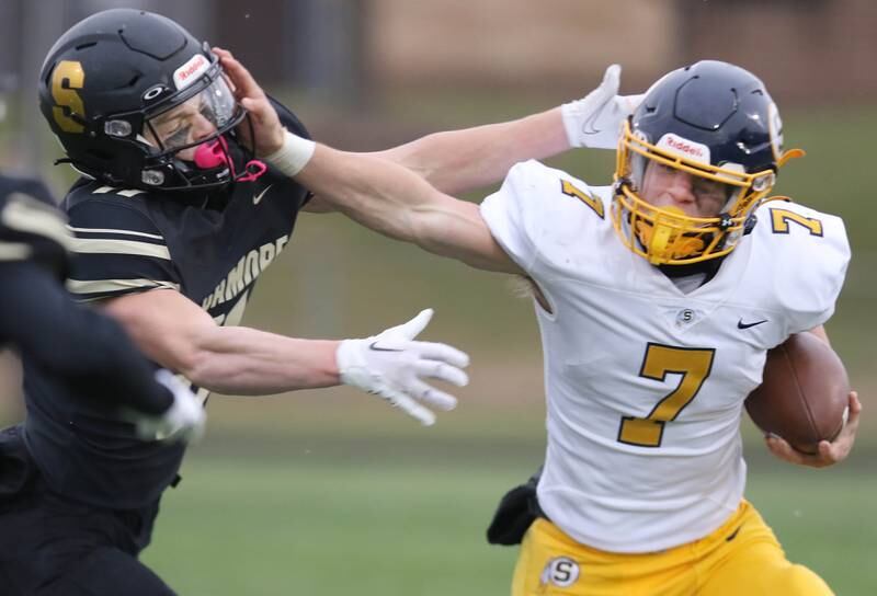 Sterling's Kael Ryan stiff arms Sycamore's Burke Gautcher during their Class 5A state playoff game Saturday, Nov. 12, 2022, at Sycamore High School.