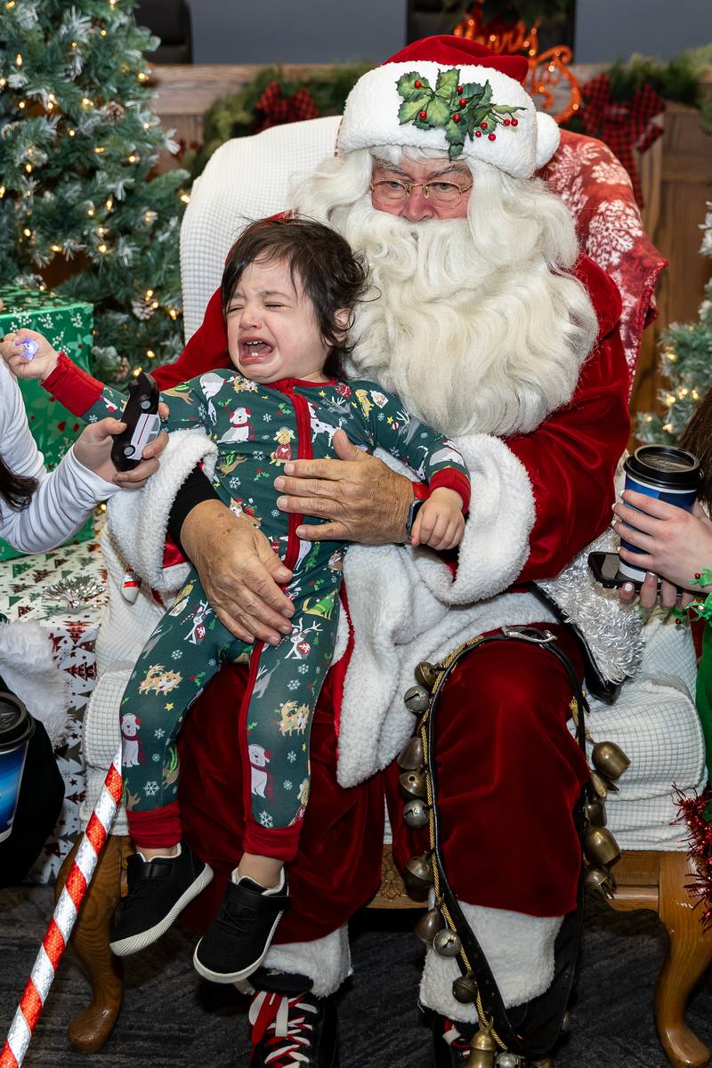 Crest Hill resident Luca Cantu takes a photo with Santa during Winterfest at Crest Hill City Center on Nov. 30, 2024.