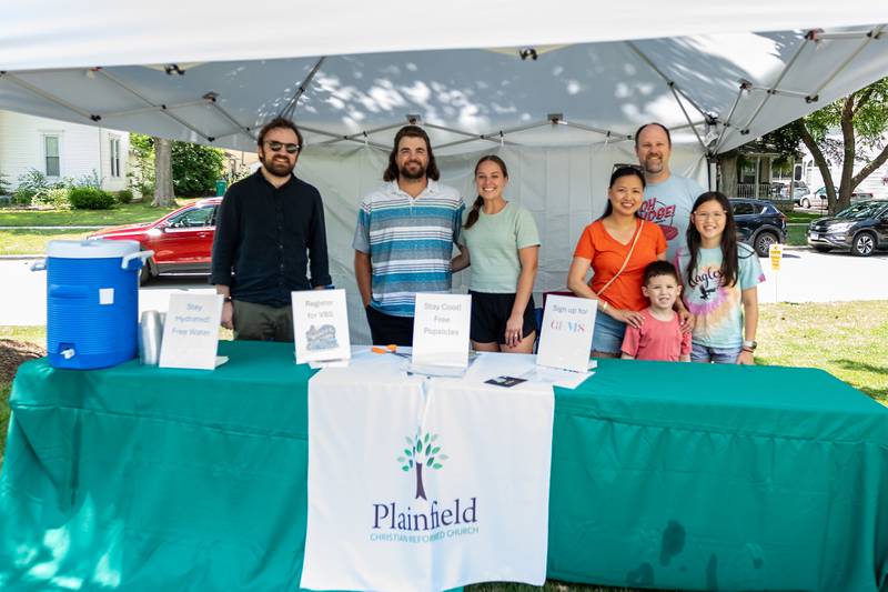 Representatives from Christian Reformed Church provide information, along with shade, popsicles and water, to Plainfield Fest attendees on a very hot afternoon on June 29, 2025.