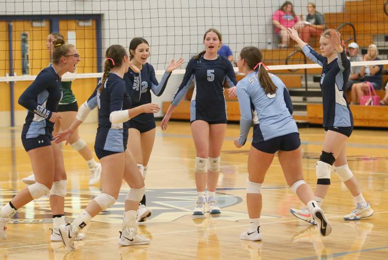 Members of the Bureau Valley volleyball team celebrate after winning the first set over St. Bede on Tuesday, Sept. 5, 2023 at Bureau Valley High School.
