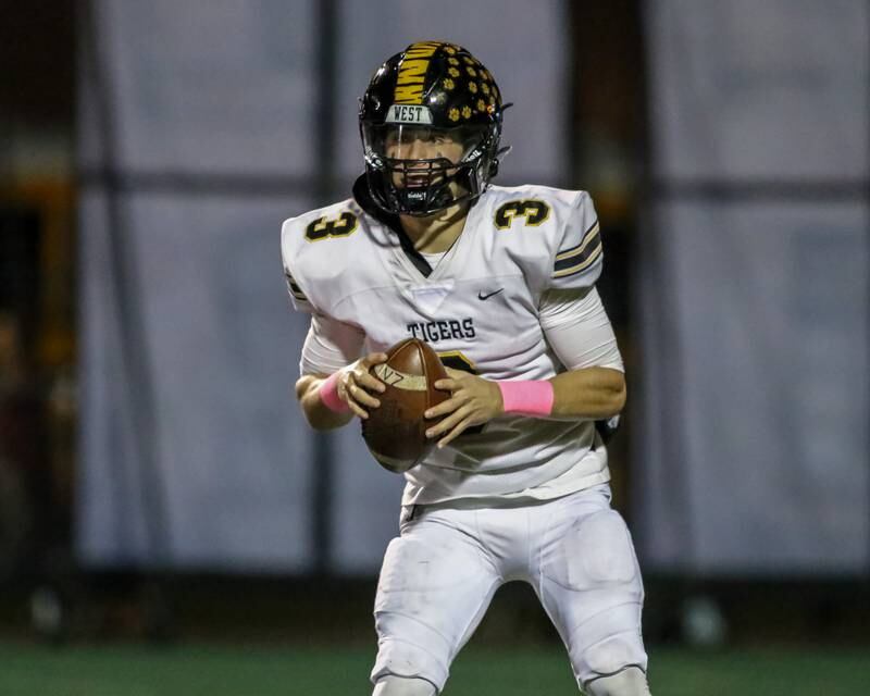 Joliet West's Juan Rico (3) looks for an open receiver during football game between Joliet West at Plainfield Central.   Oct 20, 2023.