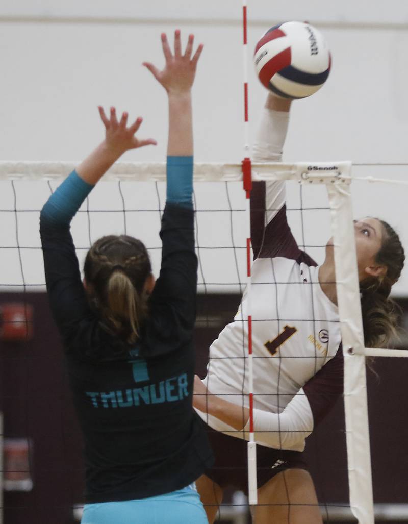 Richmond-Burton's Sophia Komar tries to hit the ball past Woodstock North's Tayler Menzel during a Kishwaukee River Conference volleyball match on Wednesday, Oct. 15, 2025, at the Richmond-Burton High School in Richmond.