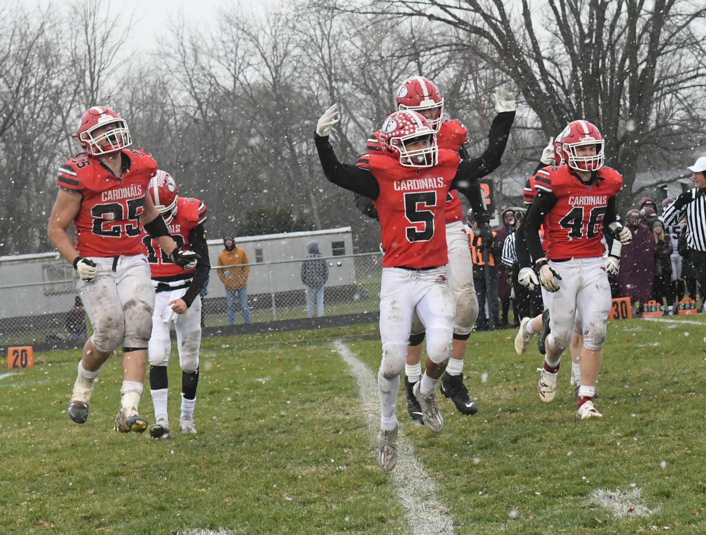 Forreston's McKeon Crase (5), Johnathen Kobler (25), and Colin Kuhn (46) celebrate as the final seconds tick off the clock during their 20-8 win over Dakota in 1A playoff action on Saturday, Nov. 12.