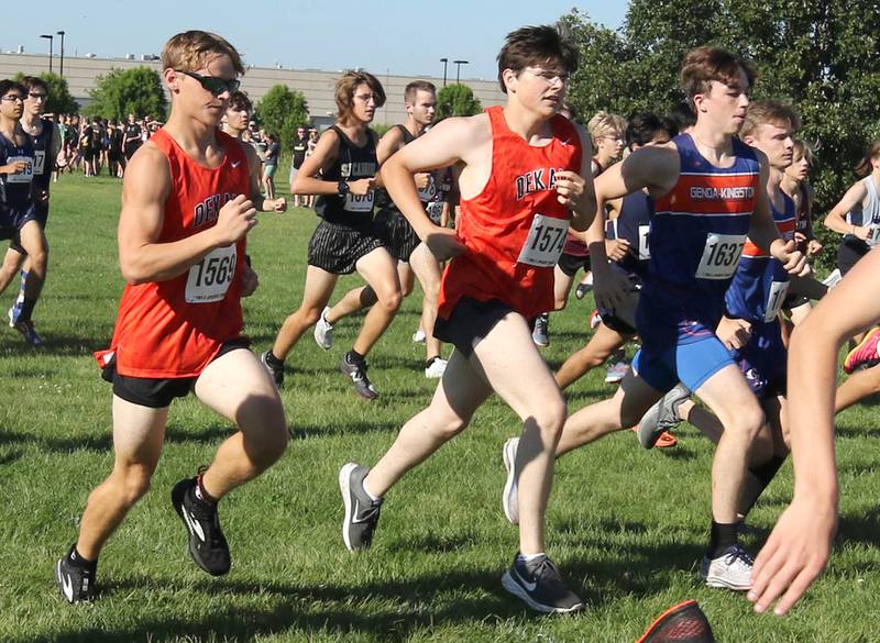 DeKalb's Zach Gennardo (left) and Donovan Whelan along with Genoa-Kingston's Myles Kendzie start in the middle of the pack Tuesday, Aug. 30, 2022, during the Sycamore Cross Country Invitational at Kishwaukee College in Malta.