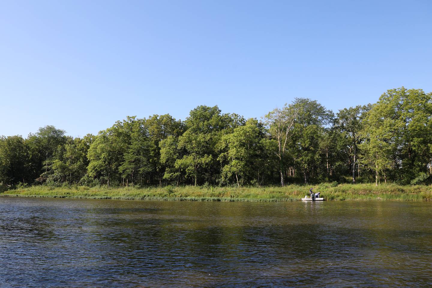 Volunteers arrive to Langham Island by boat across the Kankakee River for a Friends of Langham Island stewardship day on Aug. 9, 2025.