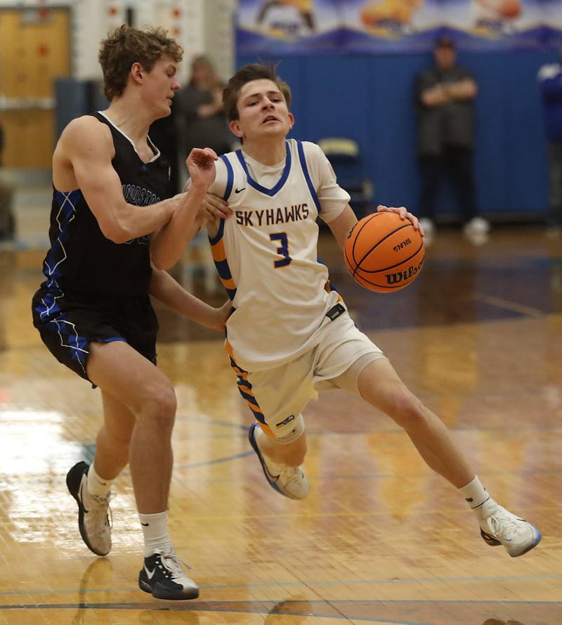 Johnsburg's Trey Toussaint tries to bring the ball up the court agaisnt Woodstock's Ty Steponitis during a Kishwaukee River Conference boys basketball game on Friday, February. 13, 2026, at Johnsburg High School.