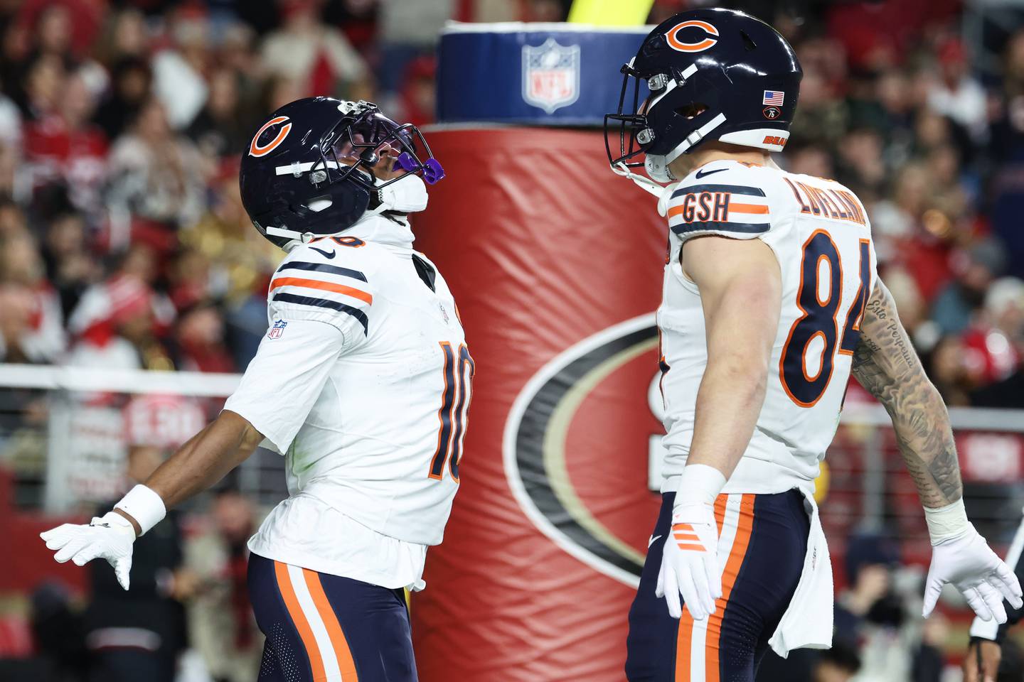Chicago Bears wide receiver Luther Burden III, left, is congratulated by tight end Colston Loveland after scoring against the San Francisco 49ers during the first half of an NFL football game in Santa Clara, Calif., Sunday, Dec. 28, 2025. (AP Photo/Jed Jacobsohn)