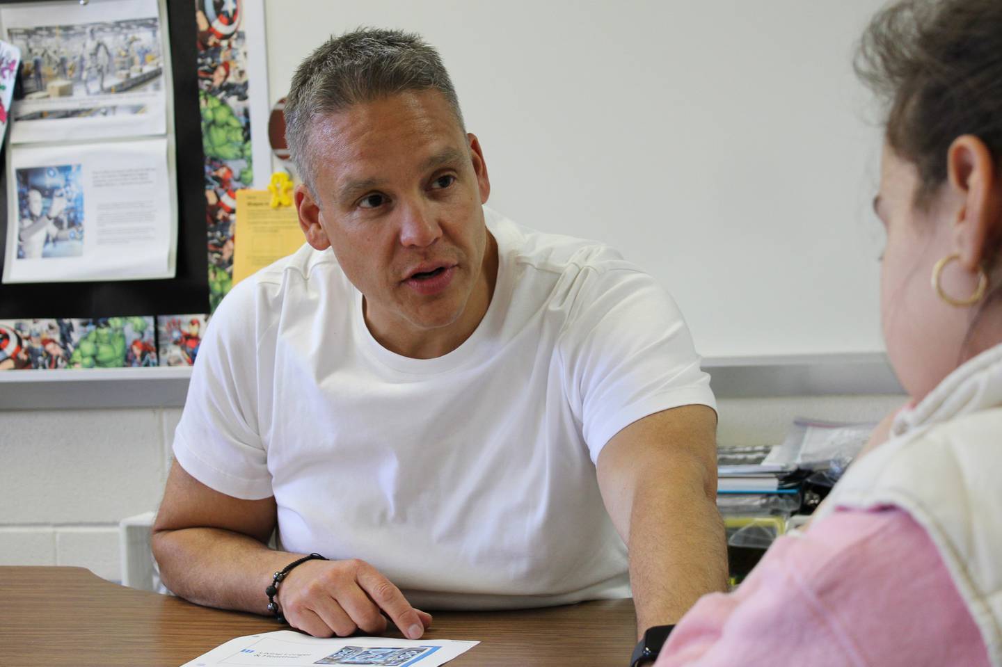 Juan Figueroa, third-grade dual language teacher at Creekside Elementary School, talks to a student in a small group session on Tuesday, April 8, 2025.
