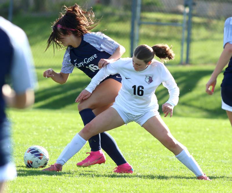Cary-Grove’s  Sam Skerl, left, battles Prairie Ridge’s Emily McPherson in varsity girls soccer at Cary-Grove High School in Cary on Tuesday, April 29, 2025.