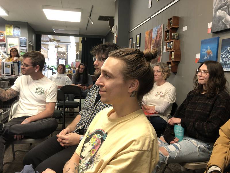 Attendees listen to an Artspace presentation Feb. 8, 2024 at Warp Corps in Woodstock.