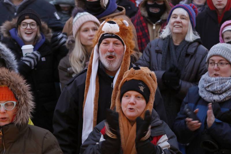 People sing along as the the Die Musik Meisters play poker music on Monday, Feb. 2, 2026, during the annual Groundhog Day Prognostication in the Woodstock Square.